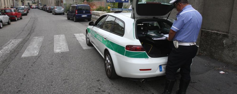 Un agente della polizia locale di Monza impegnato in un rilevamento dopo un incidente stradale