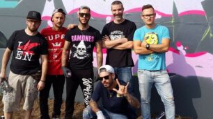 Emis Killa (al centro in piedi) con i graffitari che hanno disegnato il muro esterno della Bruno Presezzi di Burago Molgora