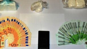 Parte della droga e del denaro sequestrati dai carabinieri al pensionato