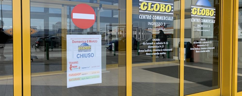Coronavirus centro commerciale globo busnago domenica cartello negozio chiuso
