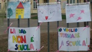 I cartelli appesi sul cancello della scuola